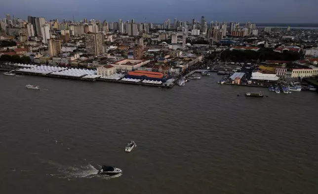 A boat moves through Guajara Bay and historic city of Belem, Para state, Brazil, Friday, Oct. 31, 2025. (AP Photo/Eraldo Peres)