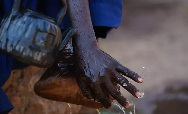 Haruna Adamu, an imam who said he has lost two brothers in the violence, performs ablutions outside a mosque in Kaduna, northwestern Nigeria, Nov. 5, 2025. (AP Photo/Sunday Alamba)