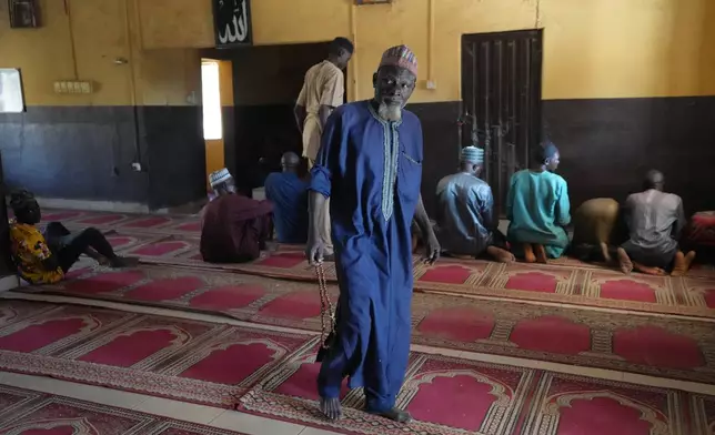 Haruna Adamu, an imam who said he has lost two brothers in his country’s violence, leaves after a prayers at a mosque in Kaduna, northwestern Nigeria, Nov. 5, 2025. (AP Photo/Sunday Alamba)