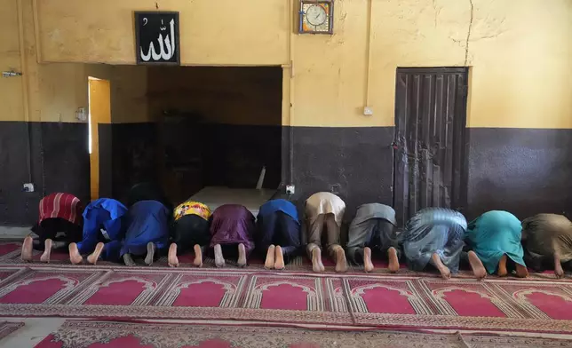 Haruna Adamu, an imam who said he’s lost two brothers to violence, prays with others at a mosque in Kaduna, northwestern Nigeria, Nov. 5, 2025. (AP Photo/Sunday Alamba)
