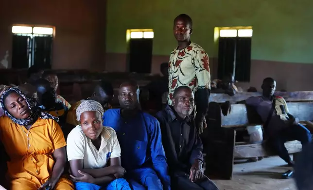 The Rev. Micah Bulus, right, standing, a pastor who was kidnapped along with others from a church service in November 2024, speaks with church members in Kaduna, northwestern Nigeria, Nov. 6, 2025. (AP Photo/Sunday Alamba)