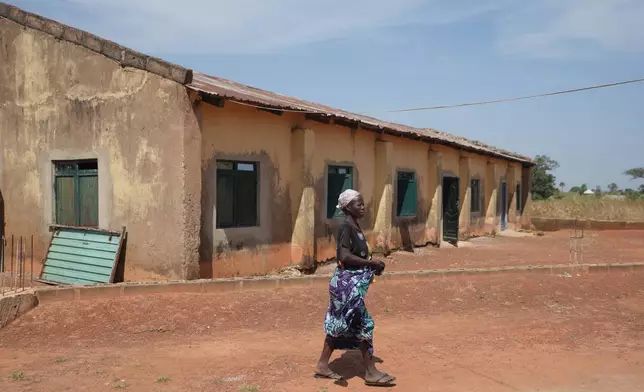 A woman walk past a church were worshipers and their pastor were kidnapped during a church service in Nov. 2024, Kaduna northwestern, Nigeria, Nov. 6, 2025. (AP Photo/Sunday Alamba)