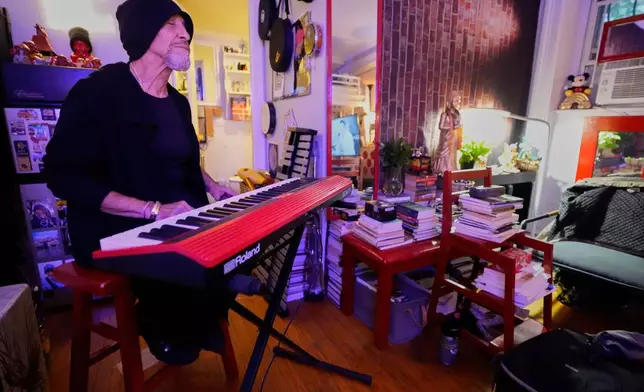 Miguel Laboy plays the keyboard after smoking cannabis, Oct. 3, 2025, in Brookline, Mass. (AP Photo/Robert F. Bukaty)