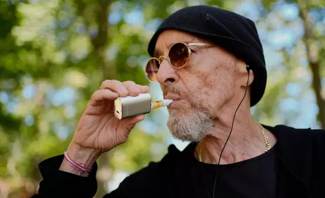Miguel Laboy, a daily cannabis user, vapes, Friday, Oct. 3, 2025, in Brookline, Mass. (AP Photo/Robert F. Bukaty)