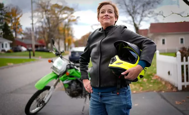 Anne Hassel, former cannabis user, poses next to her motorcycle, Nov. 6, 2025, in Chicopee, Mass. (AP Photo/Robert F. Bukaty)