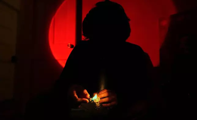 Kyle, a college student, smokes cannabis out of a bong, Oct. 29, 2025, in Boston. (AP Photo/Robert F. Bukaty)