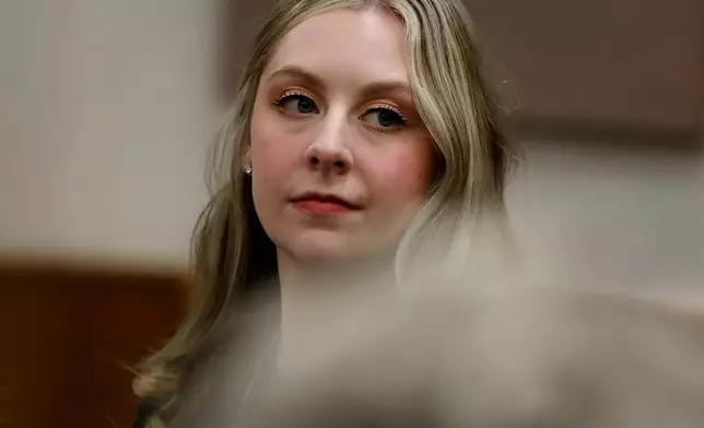 Former Richneck Elementary School teacher Abby Zwerner looks back into the courtroom during her civil lawsuit trial, Tuesday, Oct. 28, 2025, in Newport News, Va. (Stephen M. Katz/The Virginian-Pilot via AP, Pool)