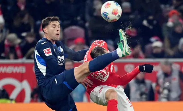 Hoffenheim's Robin Hranác, left, against Mainz's Silvan Widmer battle for the ball during the German Bundesliga soccer match between FSV Mainz 05 and TSG 1899 Hoffenheim in Mainz, Germany, Friday, Nov. 21, 2025. (Torsten Silz/dpa via AP)