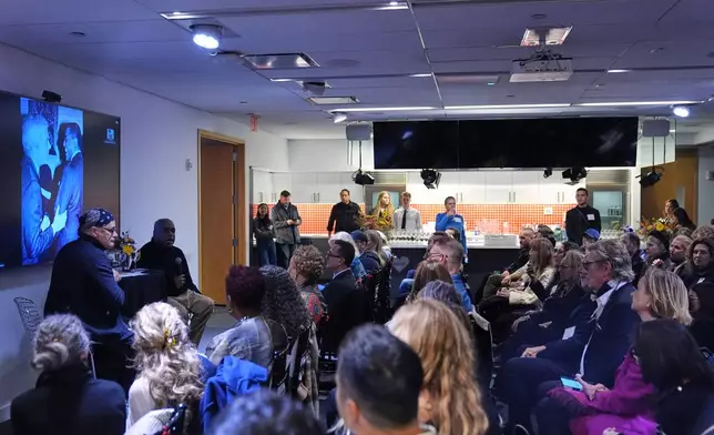 People watch as Isaac Mizrahi, left, listens to Jeffrey Banks, second from left, responds to questions during an interview Wednesday, Nov. 19, 2025, in New York. (AP Photo/Frank Franklin II)