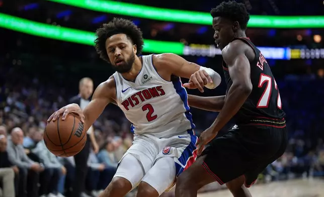 Detroit Pistons' Cade Cunningham, left, tries to get past Philadelphia 76ers' VJ Edgecombe during the first half of an NBA basketball game Sunday, Nov. 9, 2025, in Philadelphia. (AP Photo/Matt Slocum)