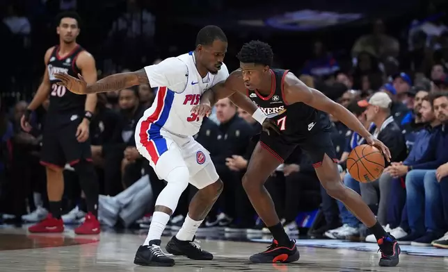 Philadelphia 76ers' VJ Edgecombe, right, tries to get past Detroit Pistons' Javonte Green during the first half of an NBA basketball game Sunday, Nov. 9, 2025, in Philadelphia. (AP Photo/Matt Slocum)