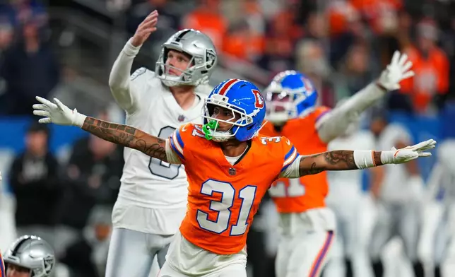 Denver Broncos' Kris Abrams-Draine (31) reacts to a missed field goal attempt by Las Vegas Raiders kicker Daniel Carlson, left, during the second half of an NFL football game Thursday, Nov. 6, 2025, in Denver. (AP Photo/Jack Dempsey)