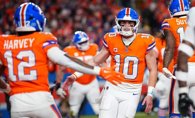 Denver Broncos quarterback Bo Nix (10) celebrates after throwing a touchdown pass during the first half of an NFL football game against the Las Vegas Raiders Thursday, Nov. 6, 2025, in Denver. (AP Photo/Jack Dempsey)