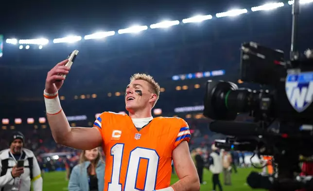 Denver Broncos quarterback Bo Nix (10) uses a phone following an NFL football game against the Las Vegas Raiders Thursday, Nov. 6, 2025, in Denver. (AP Photo/Jack Dempsey)