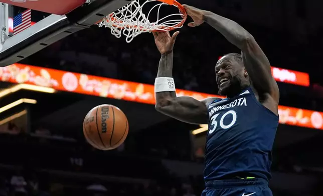 Minnesota Timberwolves forward Julius Randle (30) dunks during the first half of an NBA basketball game against the Washington Wizards, Wednesday, Nov. 19, 2025, in Minneapolis. (AP Photo/Abbie Parr)