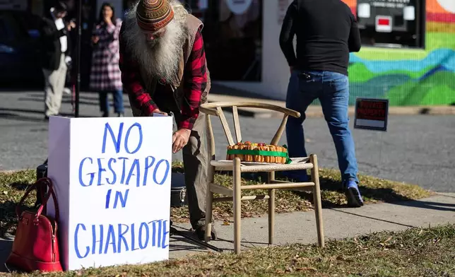 Protesters set up outside of Manolo's Bakery amidst federal law enforcement, Monday, Nov. 17, 2025, in Charlotte, N.C. (AP Photo/Matt Kelley)