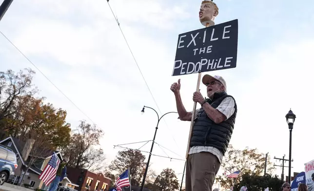 A protester reacts amidst the arrival of federal law enforcement, Tuesday, Nov. 18, 2025, in Charlotte, N.C. (AP Photo/Matt Kelley)