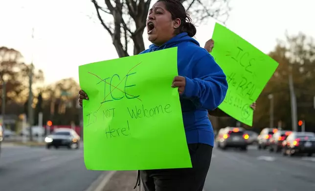 A protester reacts during the arrival of federal law enforcement, Monday, Nov. 17, 2025, in Charlotte, N.C. (AP Photo/Matt Kelley)