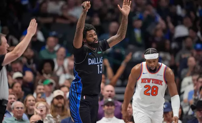 Dallas Mavericks forward Naji Marshall (13) reacts to scoring a three pointer against New York Knicks forward Guerschon Yabusele (28) in the first half of an NBA basketball game Wednesday, Nov. 19, 2025, in Dallas. (AP Photo/Tony Gutierrez)