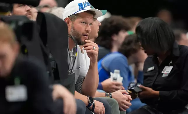 Retired Los Angels Dodgers pitcher Clayton Kershaw looks on during the first half of an NBA basketball game between the New York Knicks and Dallas Mavericks Wednesday, Nov. 19, 2025, in Dallas. (AP Photo/Tony Gutierrez)