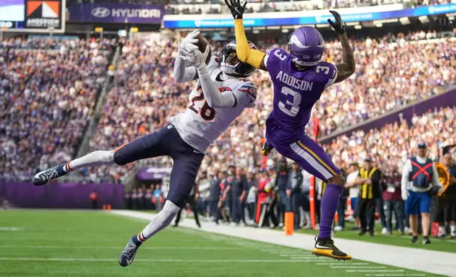 Chicago Bears cornerback Nahshon Wright (26), left, intercepts a pass intended for Minnesota Vikings wide receiver Jordan Addison (3) during the first half of an NFL football game, Sunday, Nov. 16, 2025, in Minneapolis. (AP Photo/Abbie Parr)