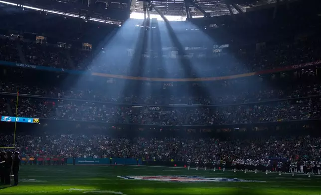 A shaft of sunlight streams into the stadium before an NFL football game between the Washington Commanders and the Miami Dolphins in Madrid, Spain, Sunday, Nov. 16, 2025. (AP Photo/Manu Fernandez)
