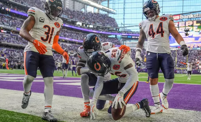 Chicago Bears cornerback Nahshon Wright (26), center, celebrates after an interception during the first half of an NFL football game against the Minnesota Vikings, Sunday, Nov. 16, 2025, in Minneapolis. (AP Photo/Abbie Parr)