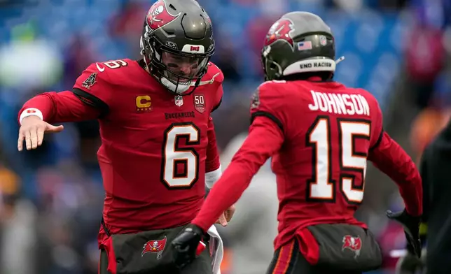 Tampa Bay Buccaneers quarterback Baker Mayfield (6) and wide receiver Tez Johnson (15) during warm ups before an NFL football game against the Buffalo Bills, Sunday, Nov. 16, 2025, in Orchard Park, N.Y. (AP Photo/Carolyn Kaster)