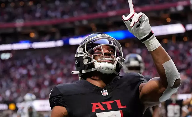 Atlanta Falcons running back Bijan Robinson (7) celebrates his touchdown against the Carolina Panthers in the first half of an NFL football game, Sunday, Nov. 16, 2025, in Atlanta. (AP Photo/Brynn Anderson)