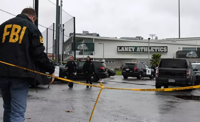 Law enforcement work the scene after a shooting at Laney College in Oakland, Calif., on Thursday, Nov. 13, 2025. (Santiago Mejia/San Francisco Chronicle via AP)