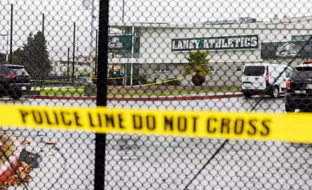 Crime scene tapes ropes off an area after a shooting at Laney College in Oakland, Calif., on Thursday, Nov. 13, 2025. (Santiago Mejia/San Francisco Chronicle via AP)