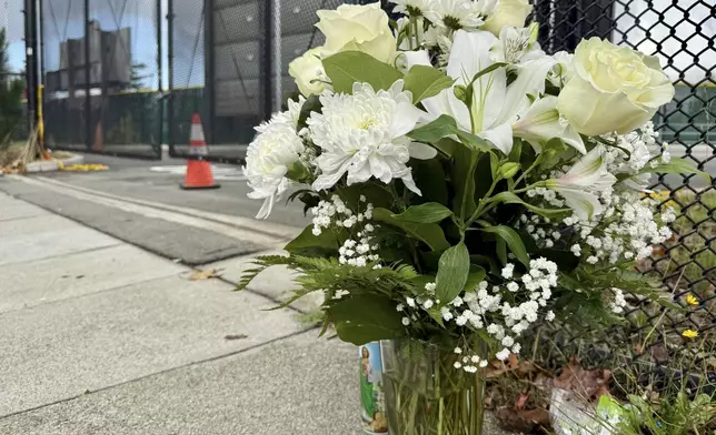 Flowers are seen on campus one day after a shooting at Laney College in Oakland, Calif., Friday, Nov. 14 2025. (AP Photo/Haven Daley)