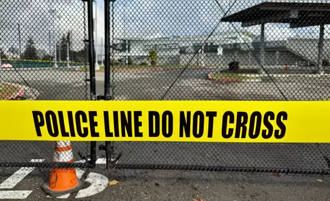 Crime scene tapes ropes off an area one day after a shooting at Laney College in Oakland, Calif., Friday, Nov. 14 2025. (AP Photo/Haven Daley)