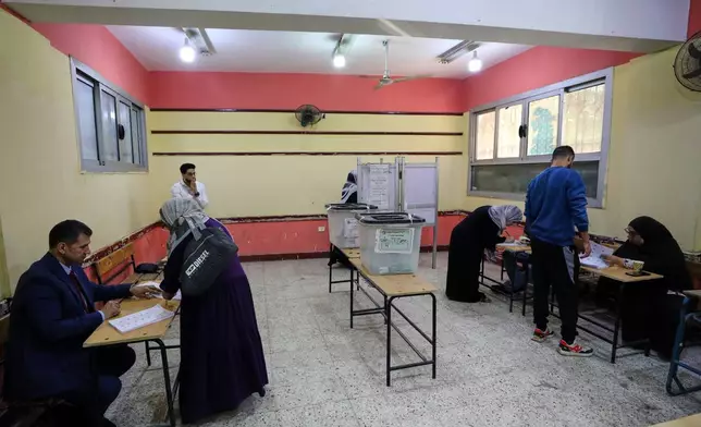 Egyptians cast their ballots during the second phase of parliamentary elections in Cairo, Egypt, Monday, Nov. 24, 2025. (AP Photo/Khaled Elfiqi)