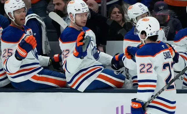 Edmonton Oilers center Matt Savoie (22) is congratulated by teammates after his goal in the second period of an NHL hockey game against the Columbus Blue Jackets in Columbus, Thursday, Nov. 13, 2025. (AP Photo/Sue Ogrocki)