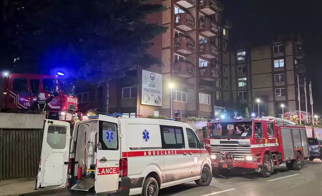 A rescue cars are parked in front of a nursing home after a fire in Tuzla, Bosnia, Tuesday, Nov. 4, 2025. (AP Photo)