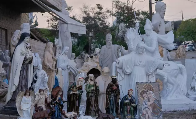 Religious statues and nativity figures are displayed for sale outside a workshop in the northeast mountain town of Kousba, Lebanon, Saturday, Nov. 15, 2025. (AP Photo/Hassan Ammar)