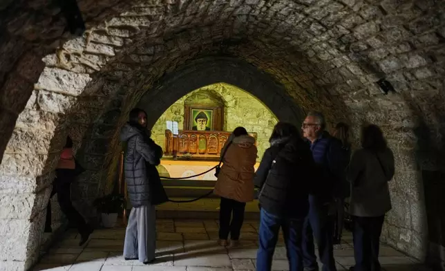 Pilgrims visit the tomb of St. Charbel inside the monastery in the northern village of Annaya, Lebanon, Saturday, Nov. 15, 2025. (AP Photo/Hassan Ammar)