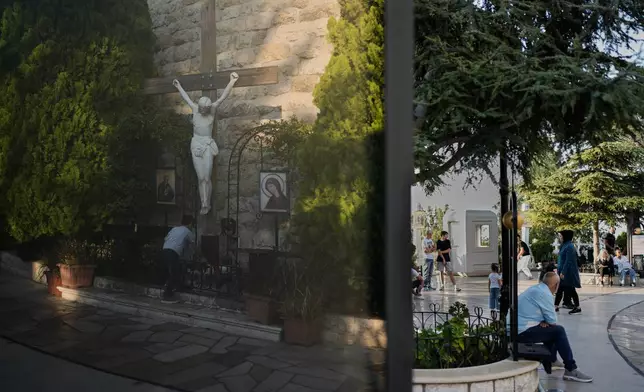 Pilgrims visit and pray around the grounds of the Our Lady of Lebanon shrine in Harissa, east of Beirut, Lebanon, Sunday, Nov. 9, 2025. (AP Photo/Hassan Ammar)