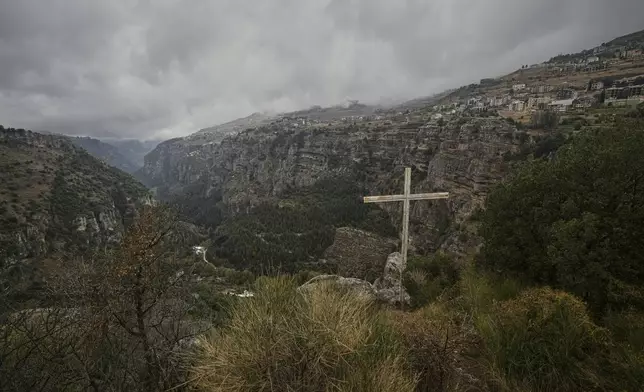 A cross stands on a cliff overlooking the Kadisha Valley, a holy site for Lebanon's Maronite Christians, near the northeast mountain town of Bcharre, Lebanon, Saturday, Nov. 15, 2025. (AP Photo/Hassan Ammar)