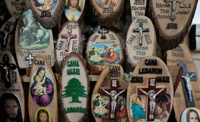 Religious souvenirs displayed for sale at a shop at the site that local tradition identifies as the location of Jesus' first miracle, turning water into wine, in the southern Lebanese village of Qana near the border with Israel, Sunday, Nov. 16, 2025. (AP Photo/Hassan Ammar)