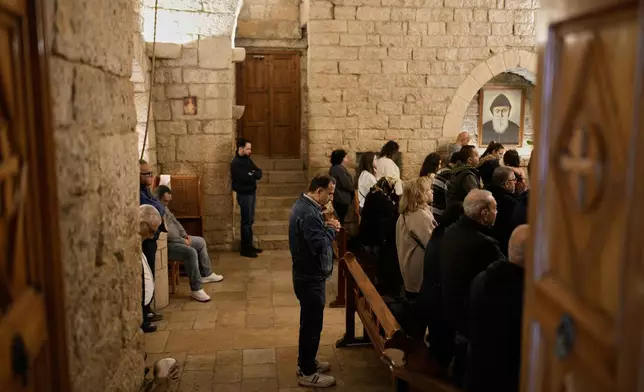 Pilgrims attend Mass in the church inside St. Charbel's monastery in the northern village of Annaya, Lebanon, Saturday, Nov. 15, 2025. (AP Photo/Hassan Ammar)