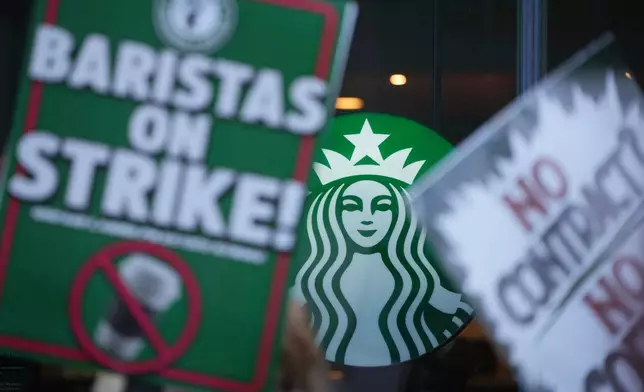 Protesters picket outside a Starbucks, Thursday, Nov. 13, 2025, in Philadelphia. (AP Photo/Matt Slocum)