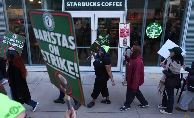 Protesters picket outside a Starbucks, Thursday, Nov. 13, 2025, in Philadelphia. (AP Photo/Matt Slocum)
