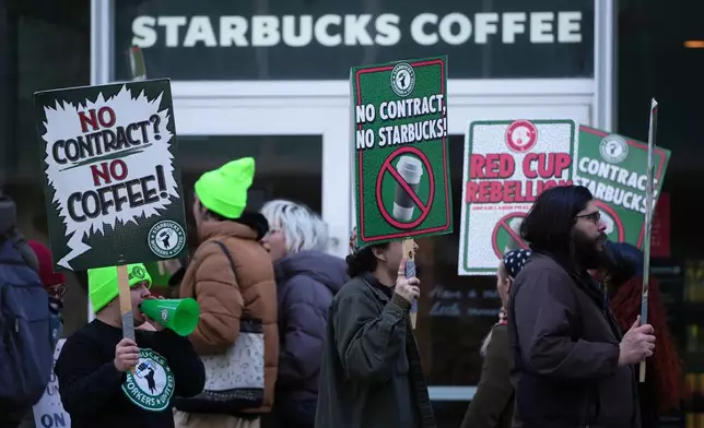 Protesters picket outside a Starbucks, Thursday, Nov. 13, 2025, in Philadelphia. (AP Photo/Matt Slocum)