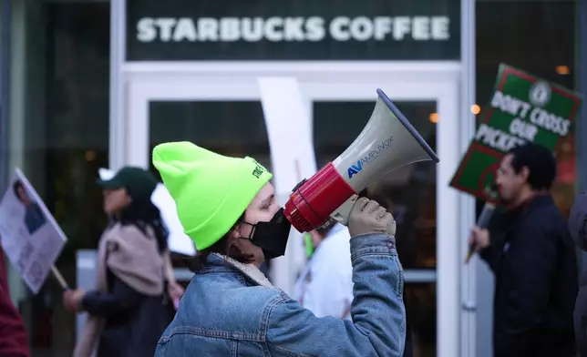 Protesters picket outside a Starbucks, Thursday, Nov. 13, 2025, in Philadelphia. (AP Photo/Matt Slocum)