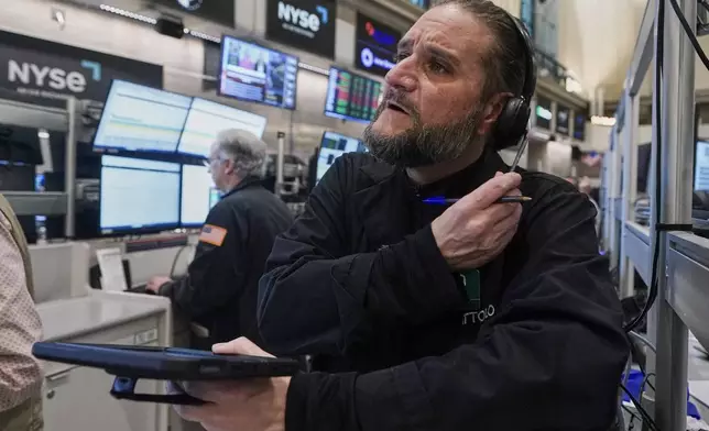 Options trader Chris Dattolo works on the floor of the New York Stock Exchange, Friday, Nov. 21, 2025. (AP Photo/Richard Drew)