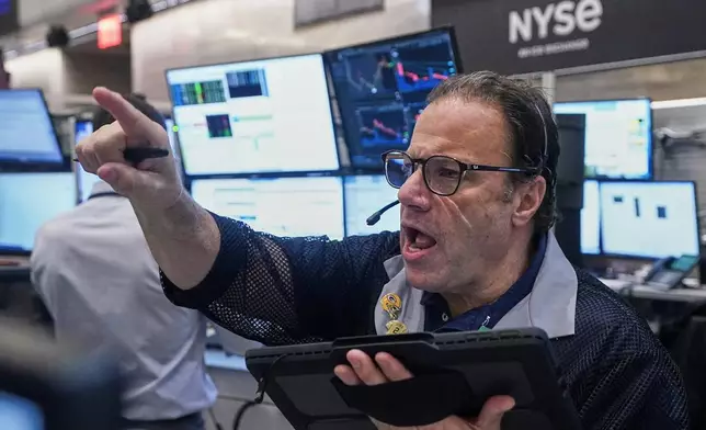 Options trader Anthony Spina works on the floor of the New York Stock Exchange, Friday, Nov. 14, 2025. (AP Photo/Richard Drew)