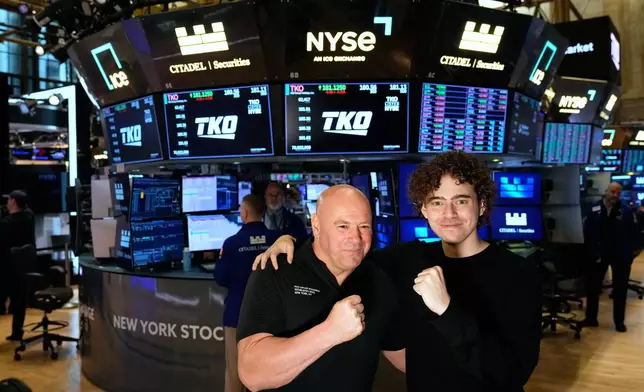 PolyMarket CEO Shayne Coplan, right, and UFC CEO Dana White pose for a picture on the floor of the New York Stock Exchange in New York, Thursday, Nov. 13, 2025. (AP Photo/Seth Wenig)