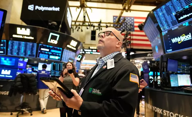 Jeffrey Vazquez works on the floor at the New York Stock Exchange in New York, Thursday, Nov. 13, 2025. (AP Photo/Seth Wenig)